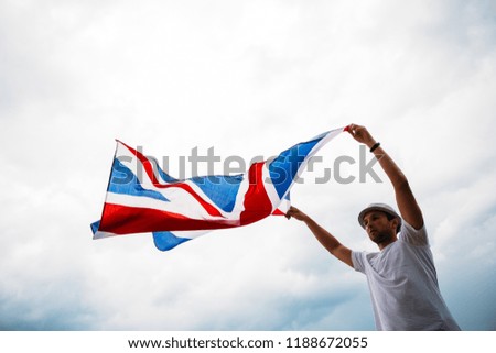 Man holding proudly the British flag. Patriot and supporter of Great Britain. 