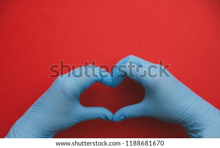 isolated hands in blue gloves with heart sign, love.