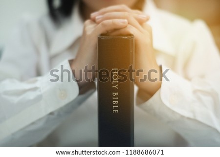Woman holding a bible in her hands and praying. Christian life crisis prayer to god. Day of Prayer, international day of prayer, hope, gratitude, thankful, trust