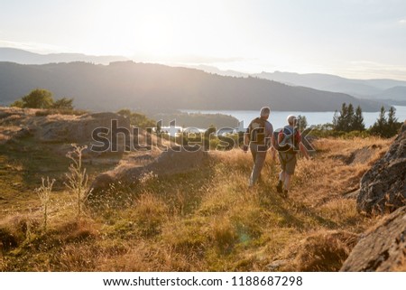 Rear View Of Senior Couple Walking On Top Of Hill On Hike Through Countryside In Lake District UK Royalty-Free Stock Photo #1188687298