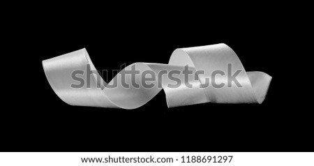 White ribbon isolated on black background and texture