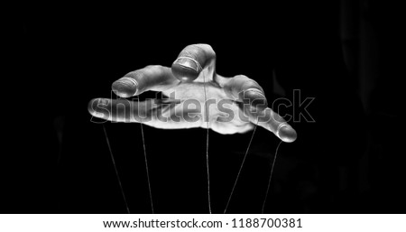 Eerie puppeteer hands controlling you. Manipulation concept Royalty-Free Stock Photo #1188700381
