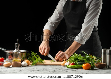 Preparation of tomato sauce by the hands of the chef, steps the process in the kitchen on a black background copy the text of the recipe.The concept of cooking food