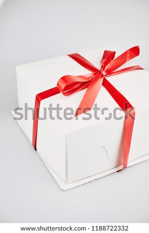 White cake box with ribbon