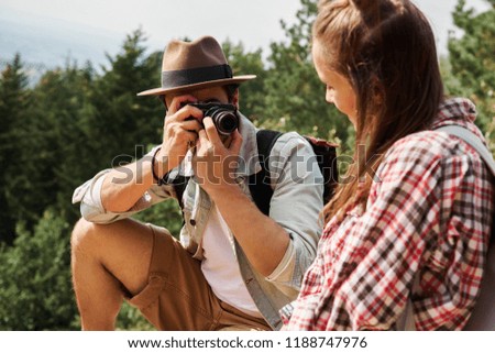 Tourist taking a photos during hiking trip 