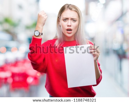 Young blonde woman holding blank paper sheet over isolated background annoyed and frustrated shouting with anger, crazy and yelling with raised hand, anger concept