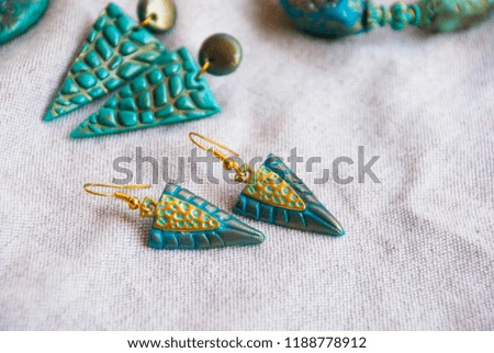 Beautiful turquoise gold bohemian style earrings. Fashion boho background accessories.
