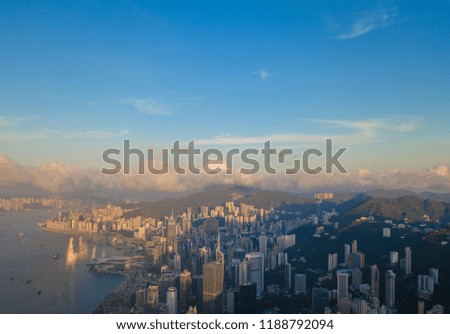 Hong Kong Downtown and Victoria Harbour. Financial district in smart city. Skyscraper and high-rise buildings. Aerial view at sunset.