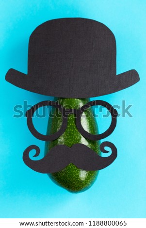Funny male silhouette pattern on the blue background. Cute party face with avocado. Prostate Cancer and men's health awareness.