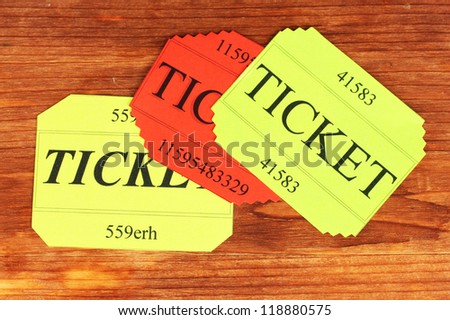 Colorful tickets on wooden background close-up