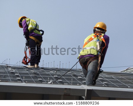 construction worker wearing ful safety to roofing metal sheet factory Royalty-Free Stock Photo #1188809236