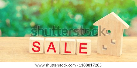 wooden house with the inscription "sale". sale of property, home, real estate. affordable housing.