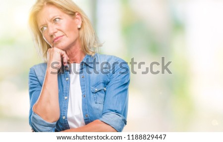 Middle age blonde woman over isolated background thinking looking tired and bored with depression problems with crossed arms.