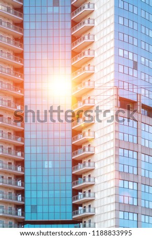 Modern office building with sun and sky reflection
