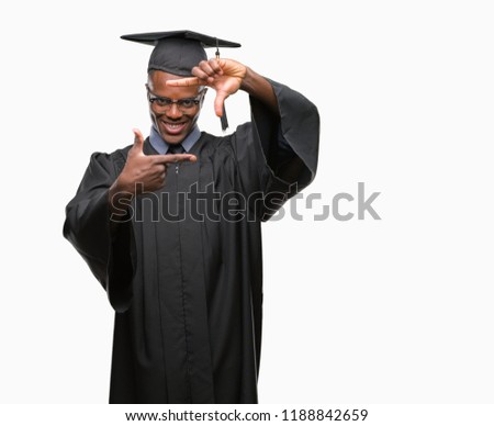 Young graduated african american man over isolated background smiling making frame with hands and fingers with happy face. Creativity and photography concept.