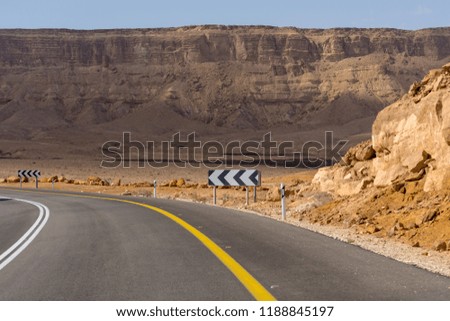 Asphalt road in desert Negev, Israel, road 40, transport infrastructure in desert, scenic mountains route in Mizpe Ramon canyon in Israel