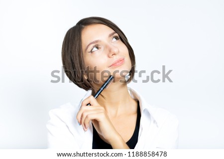 beautiful girl has a good idea, thinks with a pen, short haircut, isolated on a white background