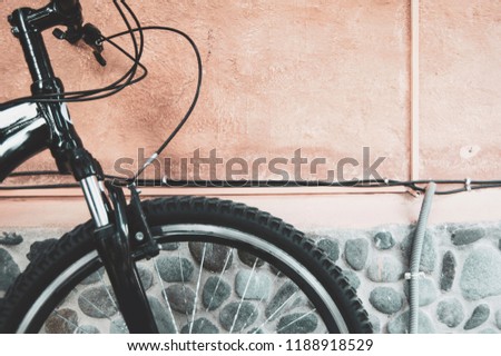 Beautiful, simple bicycle against a colorful textured wall. Vintage, classic, sports photography concept