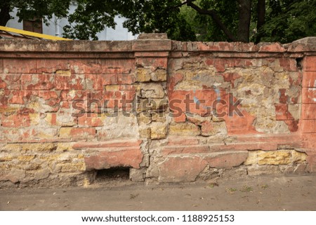 old art texture of plaster brick wall. Painted bad scratched surface in fissures of painted stucco of stone brick wall with petal texture. rubbed facade of building with damaged plaster background