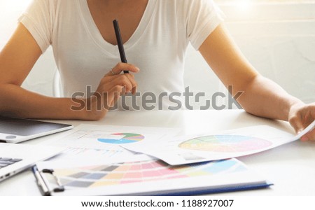 businesswomen using laptop analyzing marketing strategy with statistic graph on the table.