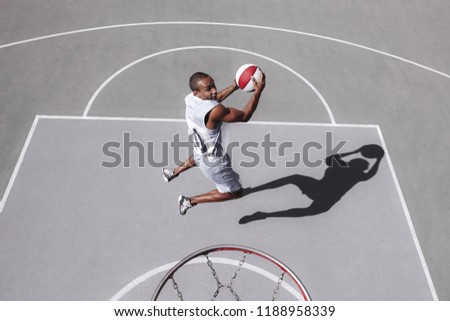 Picture of young confused african basketball player practicing outdoor. Fit afro man in motion and movement. athletic and sport lifestyle concept. Top view