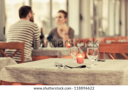 Romantic Young Couple at Restaurant Royalty-Free Stock Photo #118896622