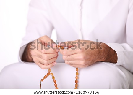 Praying hands of an young Arab Muslim man holding rosary beads, masbaha, subha, islamic concept, Royalty-Free Stock Photo #1188979156
