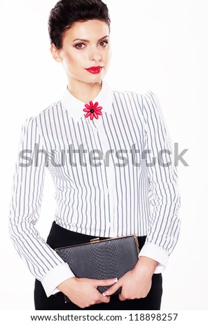 Serious luxurious lady fashion model with note book posing