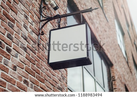 Blank square store signboard Mockup. Empty illuminated shop lightbox template mounted on the wall. Street sign, signage