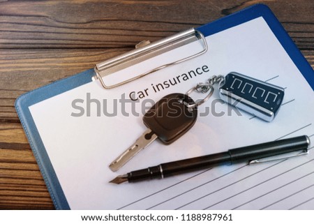 car insurance, car keys, on a wooden background.