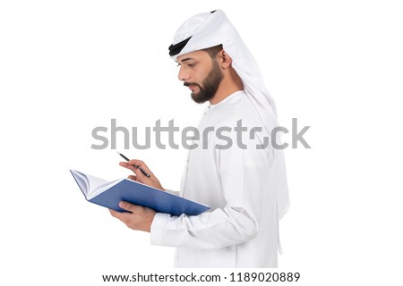 young Arab businessman standing and writing in folder, book,notebook on a white background. business concept, teacher. 