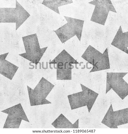 Concrete grey wall with different arrow directions texture background