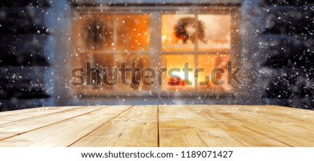 a festive wooden table by the window of a warm interior with free space for an advertising product