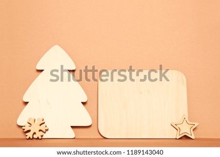 Christmas card on a red background wooden silhouettes of snowflakes, Christmas trees and a Christmas ball