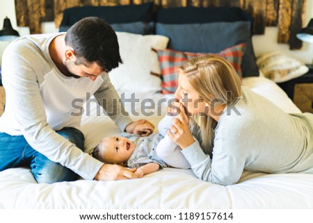 Family on bed with his baby on the morning