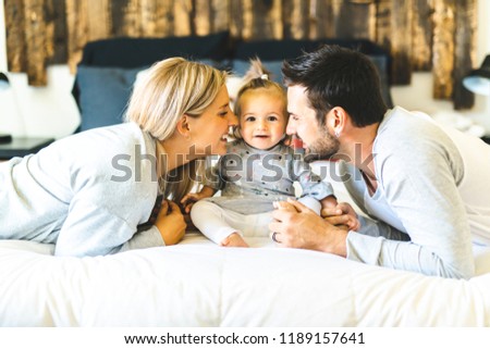 Family on bed with his baby on the morning
