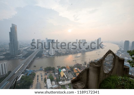 a city in asia with traffic and a river between skyscrapers