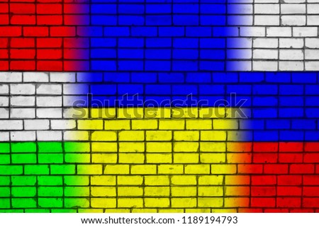 Colors of national flags of Hungary, Ukraine and Russia on a brick wall texture