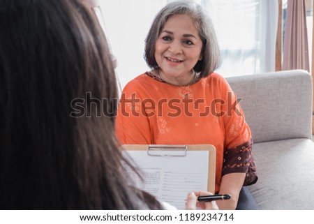 positive senior woman while in doctor office check for her health. consulting with caregiver