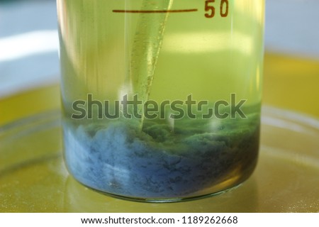 The blue precipitate of chromium carbonate settled at the bottom of the beaker. The substance is insoluble in water. Royalty-Free Stock Photo #1189262668