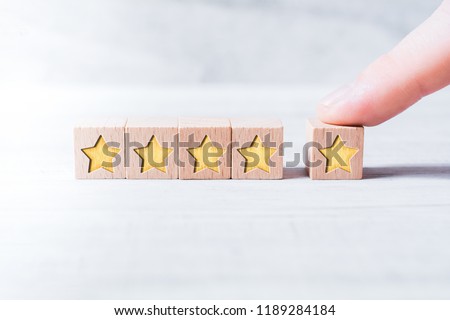 5 Star Ranking Formed By Wooden Blocks And Arranged By A Male Finger On A White Table Royalty-Free Stock Photo #1189284184