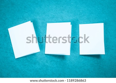 Blank portrait mock-up paper. brochure magazine isolated on blue, changeable background / white paper isolated on light blue