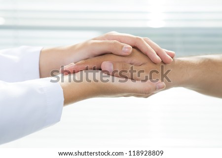 Two people holding hands for comfort Royalty-Free Stock Photo #118928809