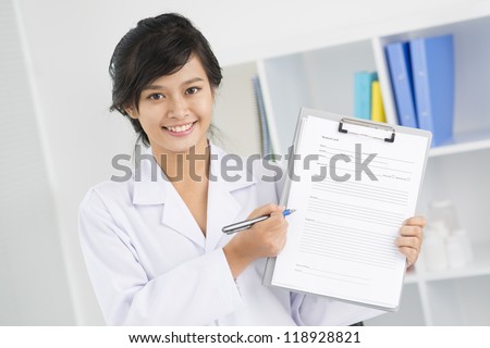 Female nurse offering to fill in medical form