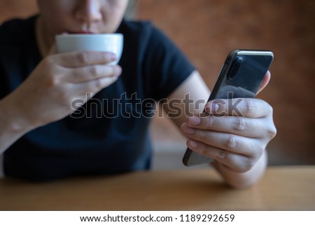 female model holds modern smart phone   relaxing in cafe coffee