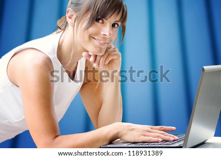 smiling girl at laptop against office background