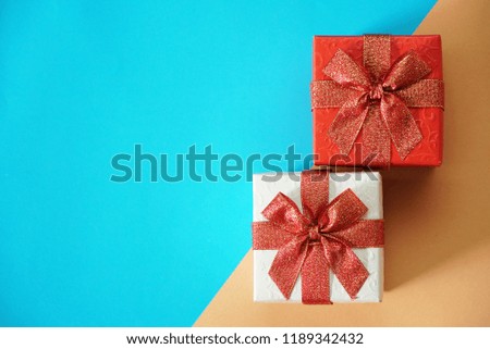 Red and white gift boxes on blue and brown background, picture have space for idea.