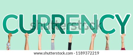 Hands holding up green letters forming the word currency
