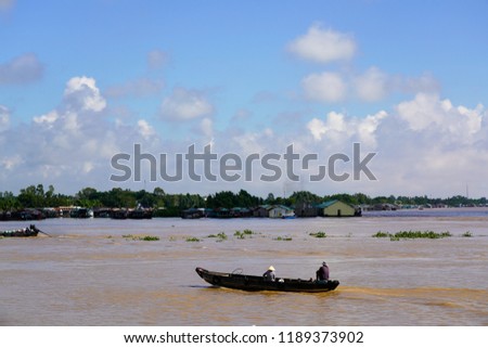 Floating village and wooden boats on Bassac River, Chau Doc, An Giang, Vietnam. The Bassac River is a distributary of the Tonle Sap and Mekong River.