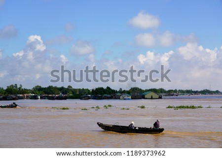 Floating village and wooden boats on Bassac River, Chau Doc, An Giang, Vietnam. The Bassac River is a distributary of the Tonle Sap and Mekong River.